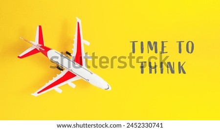 A small airplane is on a yellow background with the words Time to Think written below it