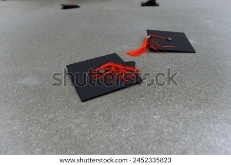A black graduation cap is thrown away by students. university graduate cap Royalty-Free Stock Photo #2452335823