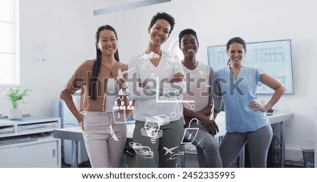 Image of globe of business icons over diverse business people smiling in office. Global business and digital interface concept digitally generated image.