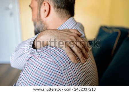 Unhappy Man Suffering From Neck Or Shoulder Pain At Home. Shoulder Pain Caused By Not Taking Care Of Health. People, Healthcare And Problem Concept.