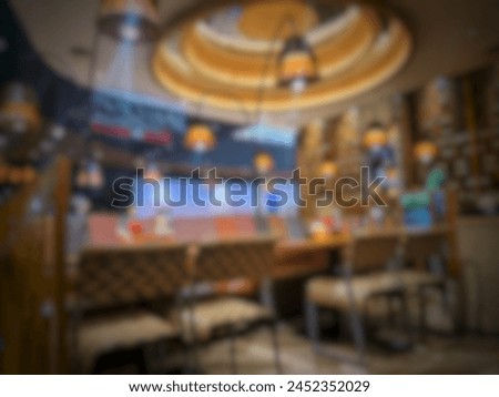 Blurred defocus photo of the interior of a Chinese restaurant in a mall in Jakarta, dominated by yellow lights, giving the impression of luxury.