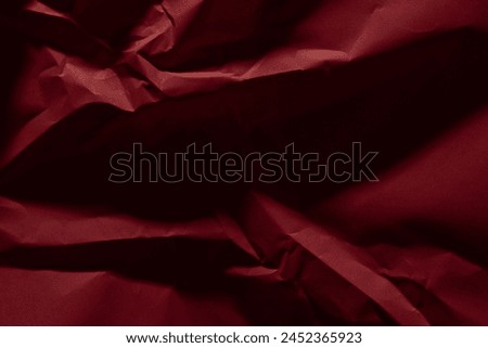Red old crumpled paper texture in low light background,wrinkled paper