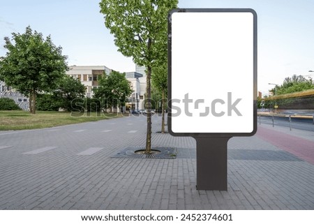 Blank Mockup Of Vertical Outdoor Poster Billboard On City Background. White Empty Advertising Lightbox On The Sidewalk
