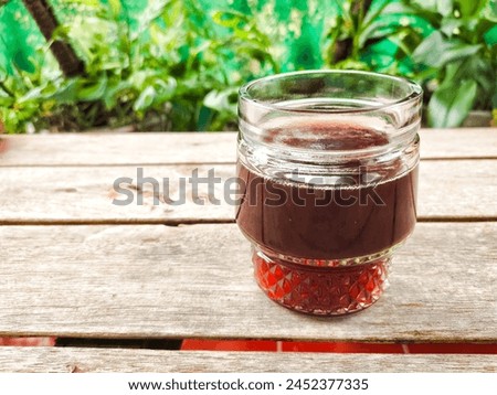 A glass of brotowali herbal medicine from Java, Indonesia. Brotowali or Tinospora cordifolia contains natural anti-inflammatory substances. Royalty-Free Stock Photo #2452377335