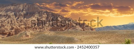 Panorama. Red Mountains of Boguty. From above, this desert canvas paints a mesmerizing picture with its intricate patterns and golden hues. Aerial artistry
