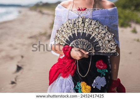 A woman shows her traditional jarocha dress in La Antigua, Veracruz. Royalty-Free Stock Photo #2452417425