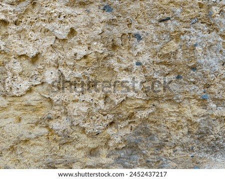 Old stone wall texture with pores and sand