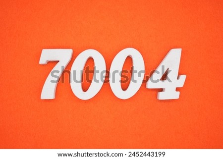 Orange felt is the background. The numbers 7004 are made from white painted wood.