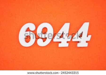 Orange felt is the background. The numbers 6944 are made from white painted wood.