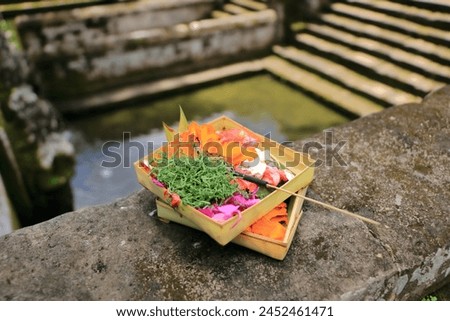 Canang Sari, the Traditional balinese offerings to gods in Bali with flowers and aromatic sticks