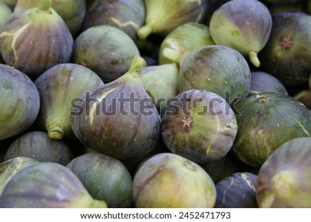 Fig. Dry fruit. Fresh slice of fig lying on a heap of ripe figs. Heap of tasty organic figs. Fresh fig available for sale in the market. Best dry fruit with a lot of health benefits. Rich in minerals.