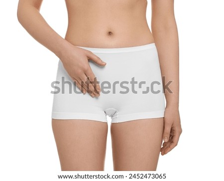 Woman holding hand near panties on white background, closeup. Women's health