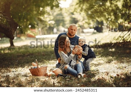 Family with little son in a autumn park