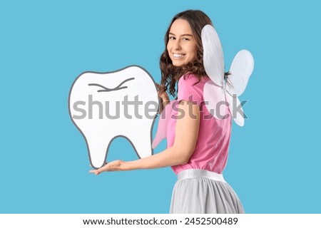 Tooth Fairy with paper figure on blue background