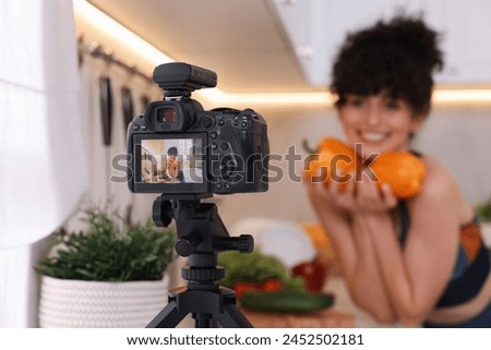 Food blogger explaining something while recording video in kitchen, focus on camera Royalty-Free Stock Photo #2452502181