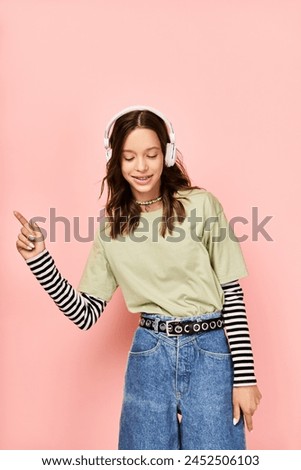 A stylish teenage girl in a bright green shirt is striking a pose while wearing headphones.