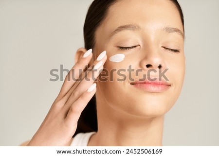 Teenage girl with eyes closed, wearing stylish vibrant attire, and a thick layer of cream on her face.
