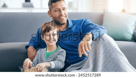 Relax, dad and son watching tv on sofa in home with popcorn, online video or streaming movie together. Film, father and child on couch for television, cartoon subscription, smile and weekend bonding