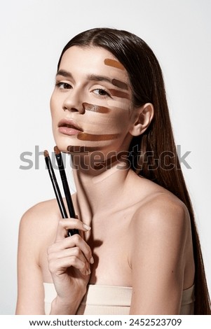young woman with makeup brushes and makeup strokes on her face, creating a creative and artistic look with foundation.