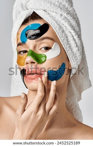 A stunning young woman with a towel wrapped around her head with eye patches on her face, enhancing her natural beauty.
