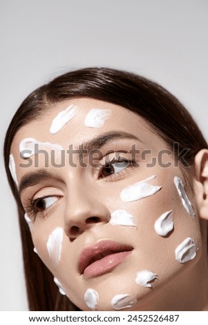 A stunning young woman posing with an abundance of white cream on her face, enhancing her natural beauty.