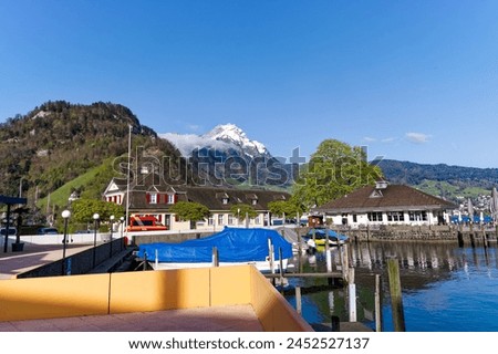 Scenic view of port at lakeshore of Lake Lucerne at Swiss village of Stansstad on a sunny spring morning. Photo taken April 11th, 2024, Stansstad, Switzerland. Royalty-Free Stock Photo #2452527137