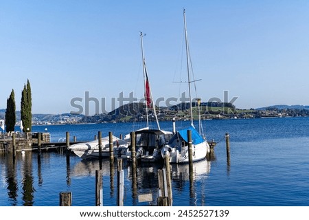 Scenic view of port at lakeshore of Lake Lucerne at Swiss village of Stansstad on a sunny spring morning. Photo taken April 11th, 2024, Stansstad, Switzerland.