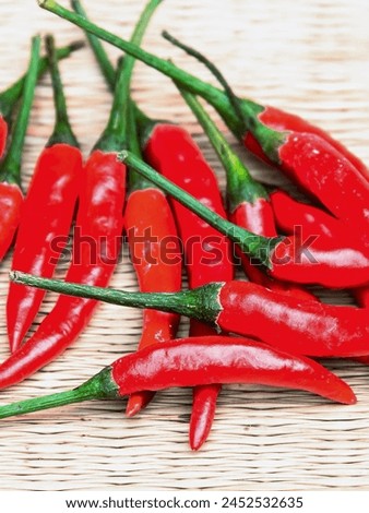 a photography of a bunch of red hot peppers on a table.
