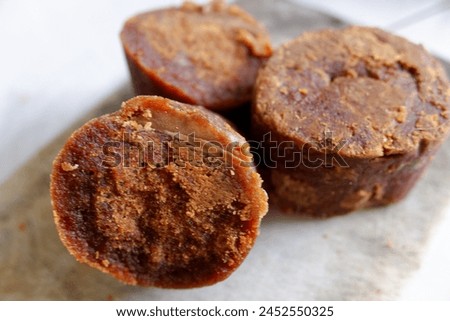 Close up of palm sugar on a white cutting board, food, stock photo.