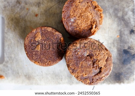Close up of palm sugar on a white cutting board, food, stock photo.