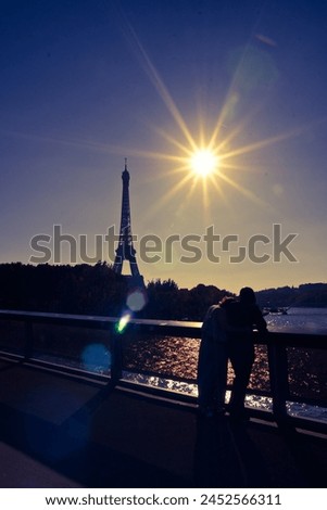 Couple in Silhouette of Eiffel Tower in Paris along river Seine