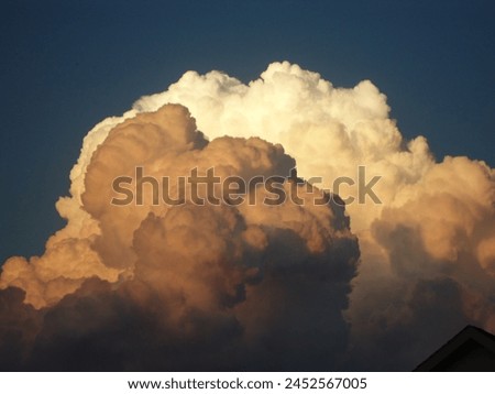 Moody white clouds loom heavily in the sky, hinting at impending rain. Atmospheric anticipation fills the air in this evocative image on you Royalty-Free Stock Photo #2452567005