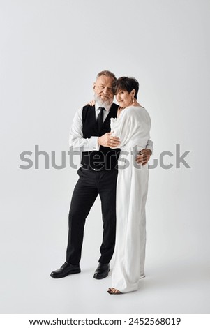 A middle-aged bride and groom in elegant formal wear pose gracefully, exuding happiness and love while celebrating a special occasion.