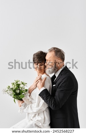 A middle-aged bride and groom in wedding gowns pose elegantly in a studio, capturing the essence of their special day.