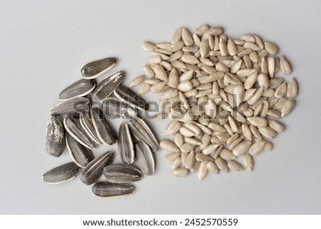 Photograph of sunflower seeds, roasted in shell and peeled without shell. Top view 