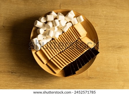 plate with snacks, cookies, marshmallows, chocolate, top view