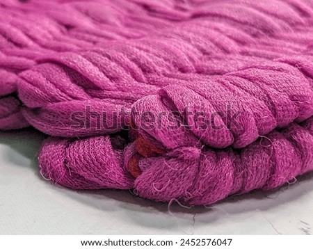 Photo of a mat made of pink fabric.