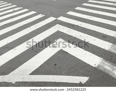 pedestrian crossing, white stripes on black asphalt, road markings zebra crossing, place to cross the road, traffic rules. crosswalk on the road for safety when people walking cross the street.