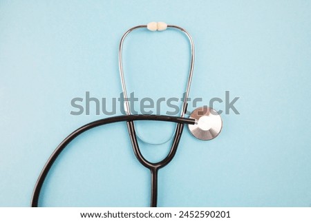 Stethoscope on a blue background. Health care concept in the new year. Copy space.