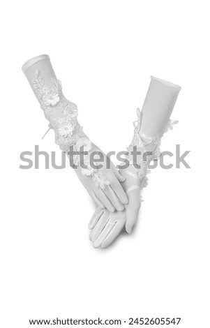 Close-up shot of a white long fingerless gloves with flowers. The pair of a white openwork mittens is crossed on a white background. Front view. Royalty-Free Stock Photo #2452605547