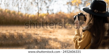 Nature photographer with dslr camera in autumn forest, Professional photography works. Banner. Copy space
