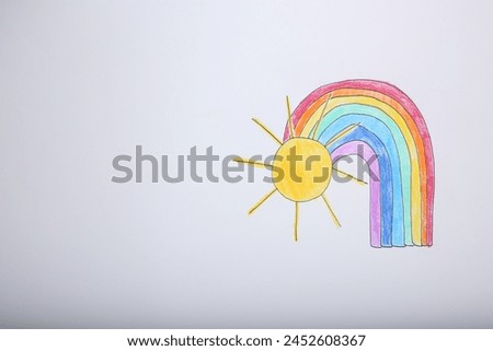 Rainbow and sun drawn on white background