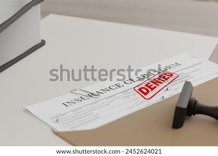 Document with denied stamp and a stamper  put on the  wooden table
