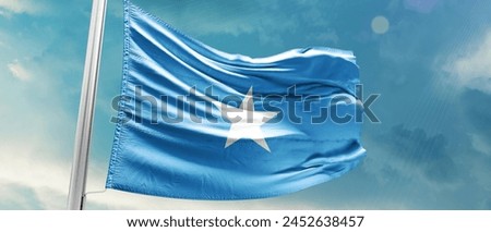 Somalia national flag waving in beautiful sky.