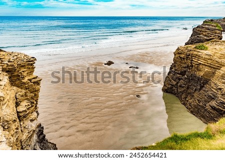 Beach of the Cathedrals, Playa las Catedrales in Ribadeo, province of Lugo, Galicia. Cliff formations on Cantabric coast in northern Spain. Tourist attraction. Royalty-Free Stock Photo #2452654421