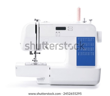 One modern sewing machine isolated on white