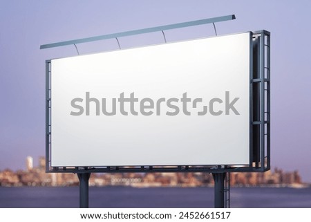 Blank white billboard on city buildings background at night, perspective view. Mockup, advertising concept