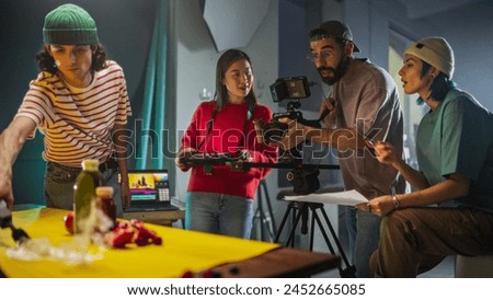 Dynamic Young Film Crew Engaged In A Lively Discussion On A Colorful Set, With A Female Asian Cinematographer Adjusting A Camera As Her Diverse Team Collaborates On A Creative Video Production Project