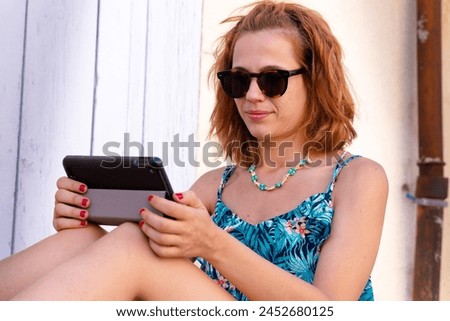 Side view caucasian woman with digital tablet outdoors.