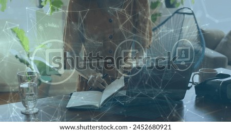 Image of network of connections with media icons over caucasian woman taking notes. social media and communication interface concept digitally generated image.